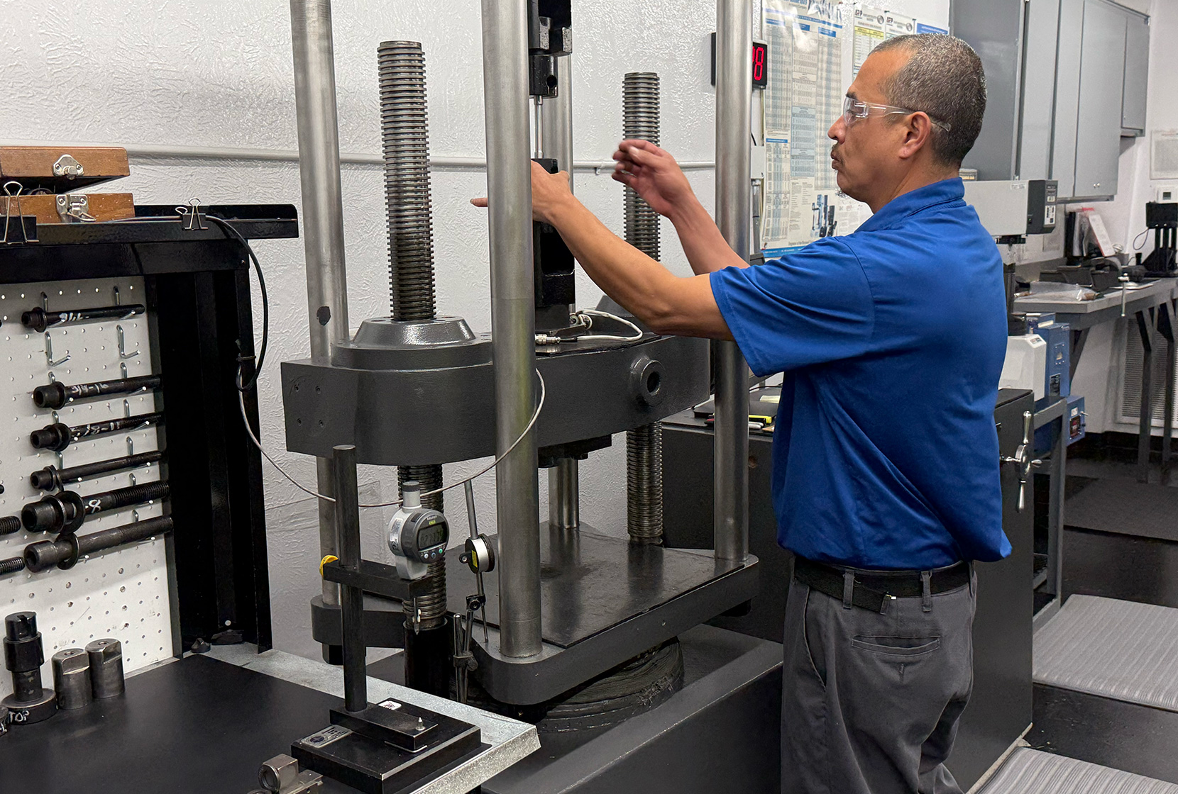 All-Pro Fasteners employee testing fasteners in A2LA accredited quality assurance testing lab.